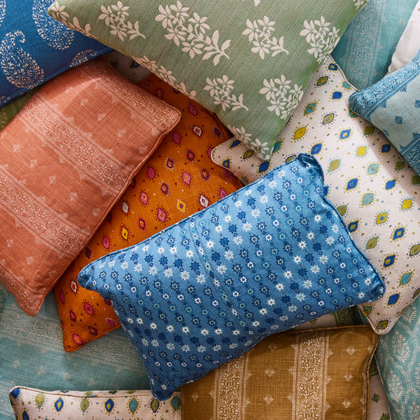 a pile of colorful, patterned pillows